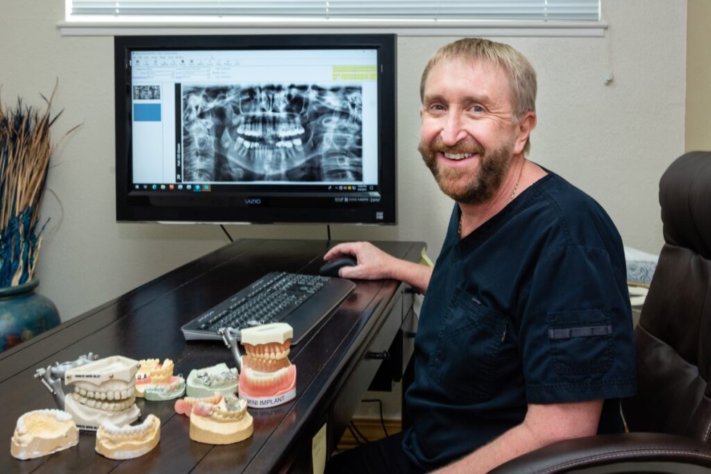 Dr Steichen At The Computer With Dental Models On The Desk