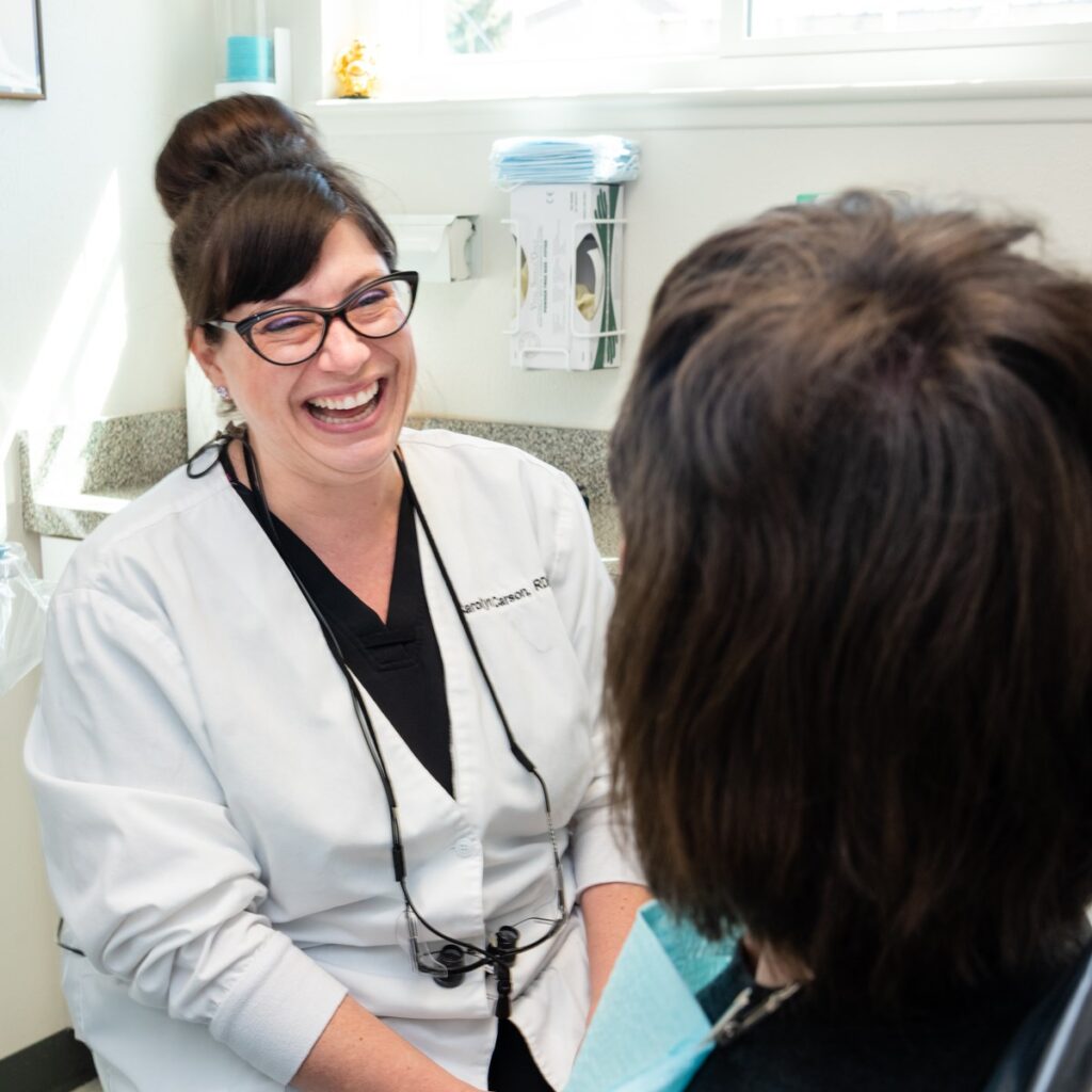 Dental Assistant At Precision Dental Care Giving A Consultation To A Dental Patient